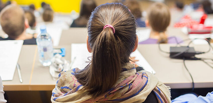 Viele junge Menschen sitzen in einem Hörsaal